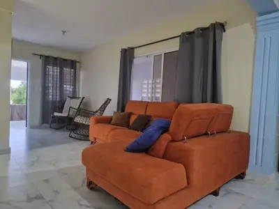 a living room with a couch and a chair at Flor D Loto in Bejuquero