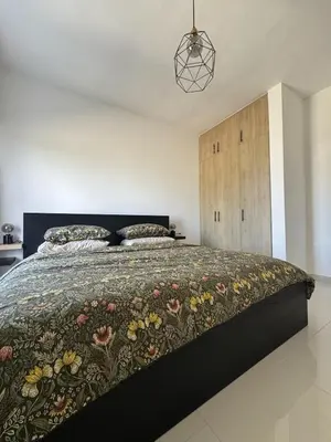 a bedroom with a large bed with a floral bedspread at Terraza Caribeña in Bayahibe