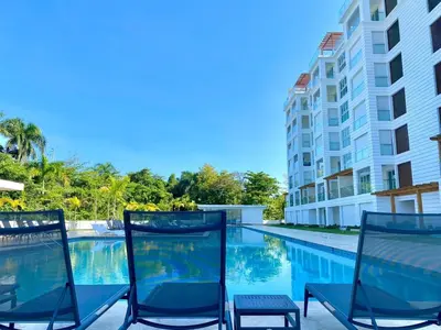two chairs sitting next to a swimming pool at Fortunity1 Escape, Puerto plata Playa Dorada in San Felipe de Puerto Plata