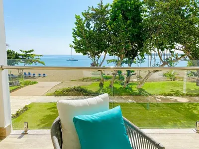 a couch on a balcony with a view of the ocean at Fortunity1 Escape, Puerto plata Playa Dorada in San Felipe de Puerto Plata