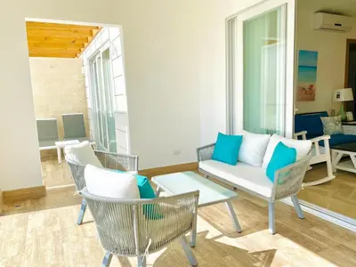 a living room with chairs and a couch at Fortunity1 Escape, Puerto plata Playa Dorada in San Felipe de Puerto Plata