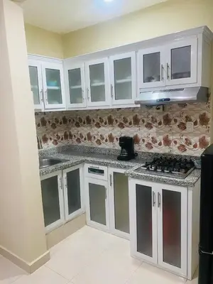 a kitchen with white cabinets and a counter top at Apartamento Familiar 7 in Colorado