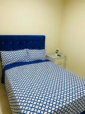 a bedroom with a blue bed with a blue and white comforter at Apartamento Familiar 7 in Colorado