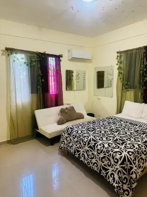 a bedroom with a bed and a couch in it at El patio de Lucia, center 4 people Las Terrenas in Las Terrenas