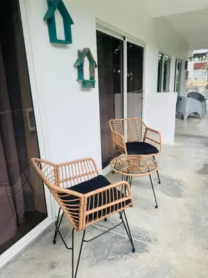 two chairs and a table in front of a store at El patio de Lucia, center 4 people Las Terrenas in Las Terrenas