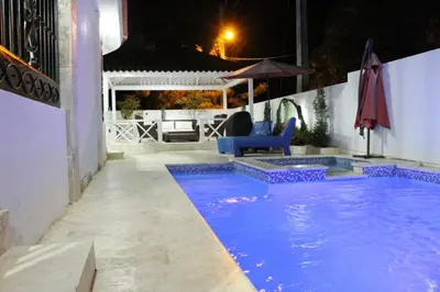 a swimming pool in a backyard at night at Villa luxury Cabarete in Cabarete