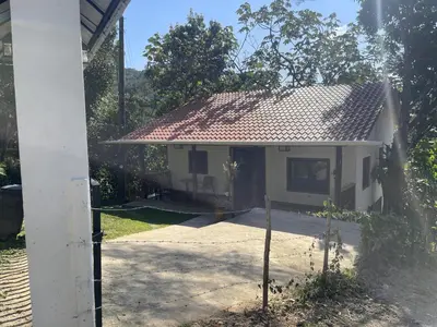 a small white house with a red roof at Villa Jarabacoa Monte Bonito in Jarabacoa