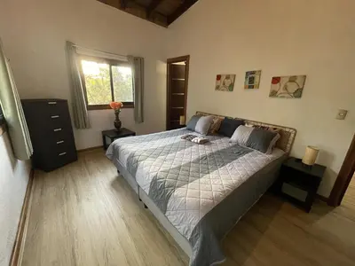 a bedroom with a bed and a window at Villa Jarabacoa Monte Bonito in Jarabacoa