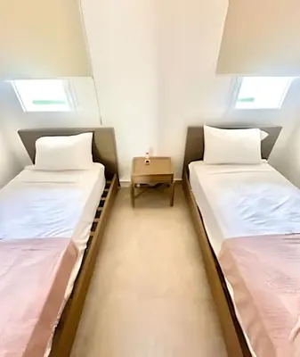 two beds in a small room with two windows at Aqua Esmeralda by Advantage Club in La Laguna