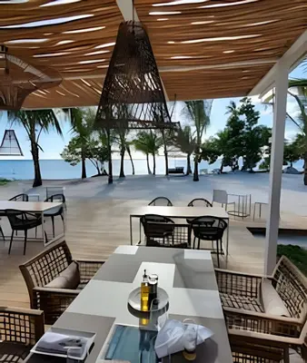 a restaurant with tables and chairs and a view of the beach at Aqua Esmeralda by Advantage Club in La Laguna