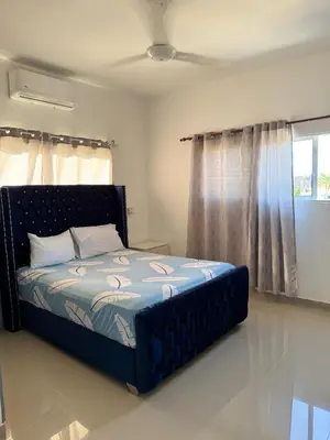 a bedroom with a bed in a room with a window at Colina Residence in Las Terrenas