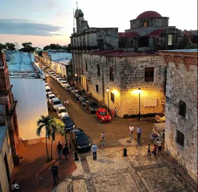 a group of cars parked in a parking lot next to a building at Lovely apartment colonial zone in Santo Domingo