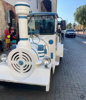 a white train engine is parked on a street at Lovely apartment colonial zone in Santo Domingo