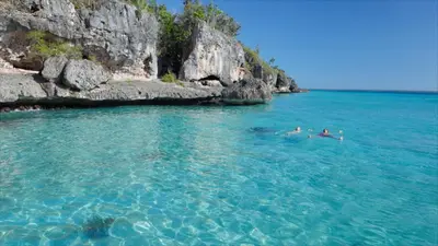a group of people swimming in a body of water at Apartamento amueblado a 5 minutos de la playa in Bayahibe