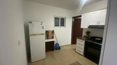 a kitchen with a white refrigerator and a stove at Apartamento amueblado a 5 minutos de la playa in Bayahibe
