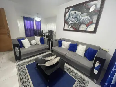a living room with two couches and a table at Apartamento en Caleta, La Romana in La Romana