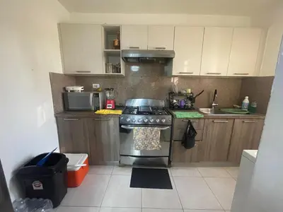 a kitchen with a stove and a microwave at Apartamento en Caleta, La Romana in La Romana