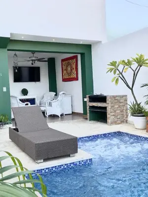 a living room with a pool with a couch and a piano at Casa con piscina Romana del Oeste in La Romana