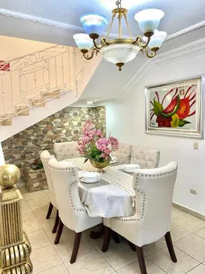 a dining room with a table and chairs and a chandelier at Casa con piscina Romana del Oeste in La Romana