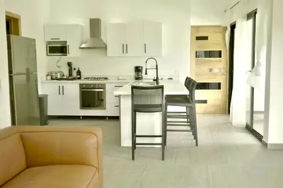 a kitchen with a couch and a table and chairs at Best Friends Hoyo Cacao in Las Terrenas