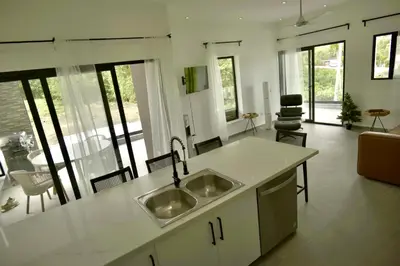 a kitchen with two sinks and a living room at Best Friends Hoyo Cacao in Las Terrenas