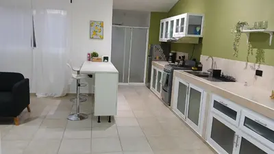 a kitchen with green walls and a counter top at Kassuky Home in Cabarete