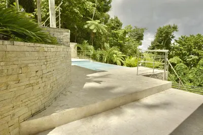 a staircase leading to a swimming pool in a house at Villa Jimi Las Terrenas in El Naranjito