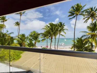 a view of the beach from a balcony at The Ocean Front Palomar in Punta Cana