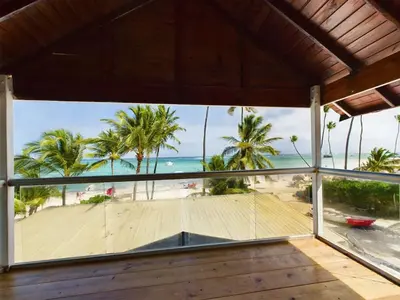 a view of the beach from the balcony of a beach house at The Ocean Front Palomar in Punta Cana