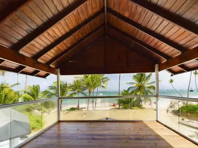 a room with a view of the beach and the ocean at The Ocean Front Palomar in Punta Cana
