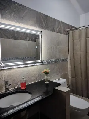 a bathroom with a sink and a toilet and a mirror at Villa Magante in La Yagua