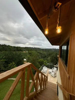 a balcony of a wooden cabin with a view at Villa con piscina Infinitive in Concepción de La Vega