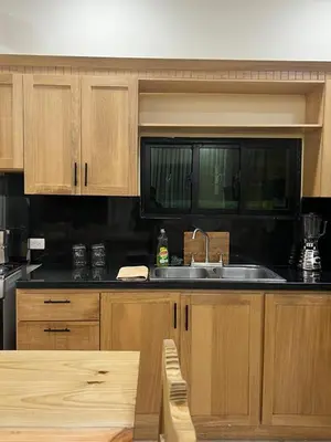 a kitchen with wooden cabinets and a sink at Villa con piscina Infinitive in Concepción de La Vega