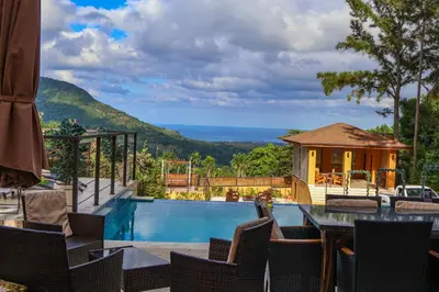 a resort with a swimming pool and a house at Villa Paz in San Felipe de Puerto Plata