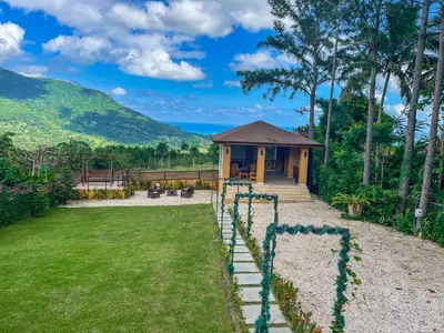 a house with a garden and a playground at Villa Paz in San Felipe de Puerto Plata
