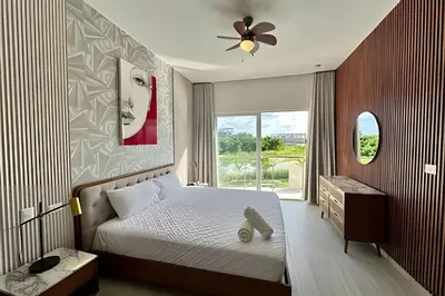 a bedroom with a bed with a teddy bear sitting on it at Adult Only Luxe Retreat @ Coral Bay 2 in Punta Cana