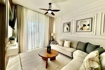a living room with a couch and a table at Adult Only Luxe Retreat @ Coral Bay 2 in Punta Cana