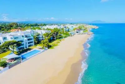 an aerial view of a beach with houses and the ocean at Beachfront Luxury Penthouse in Sosúa