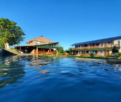 a view of a river with buildings in the background at Habitacion 3 en Dani's Guest House in Las Galeras