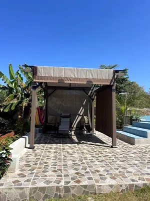 a pavilion with a table and chairs on a patio at Habitacion 3 en Dani's Guest House in Las Galeras