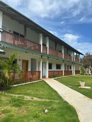 an exterior view of a building with a yard at Habitacion 4 en Dani's Guest House in Las Galeras
