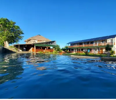 a view of a river with buildings in the background at Habitacion con Jacuzzy en Dani's Guest House in Las Galeras