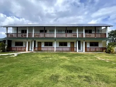 a large white building with a large yard at Habitacion con Jacuzzy en Dani's Guest House in Las Galeras