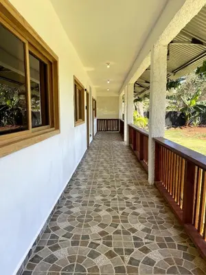 a corridor of a house with a tiled floor and windows at Habitacion con Jacuzzy en Dani's Guest House in Las Galeras