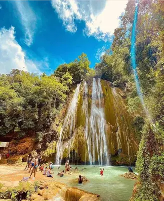 a group of people in the water at a waterfall at Habitacion con Jacuzzy en Dani's Guest House in Las Galeras