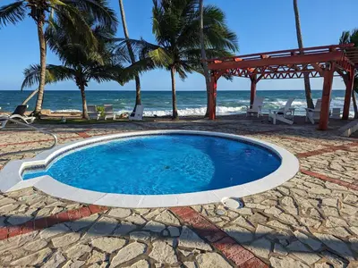 a swimming pool on a beach with the ocean at Jardines del Mar Todas las Amenidades Reserva Inmediata in Villas del Mar
