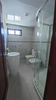 a bathroom with two toilets and a glass shower at Blue apt H1 - two queen bedroom - POOL- in Sosúa