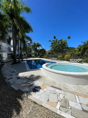 a swimming pool in a yard with palm trees at Blue apt H1 - two queen bedroom - POOL- in Sosúa