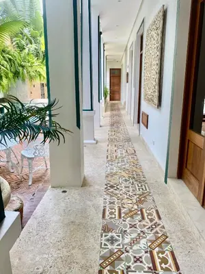 a hallway with tile flooring in a house at Boutique Hotel Casa Grande, Parrot's Paradise Suite in Santo Domingo