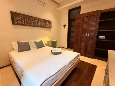 a bedroom with a large white bed in a room at Boutique Hotel Casa Grande, Mango Tango Suite in Santo Domingo
